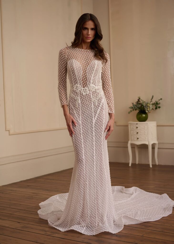 An exquisite blend of romance and sophistication, the Paris gown is crafted from delicate sheer tulle embroidered with soft polka-dot textures.